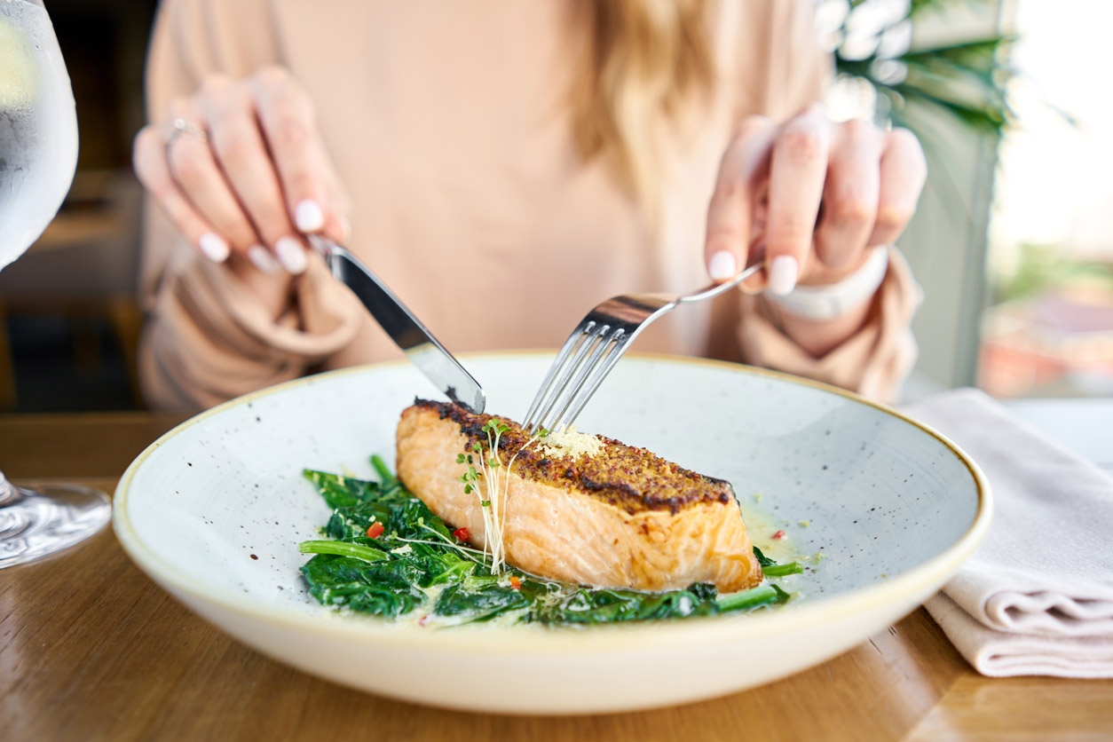 Woman eating fish