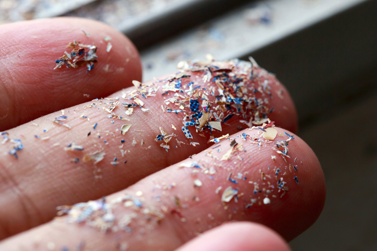 Hand holding microplastics