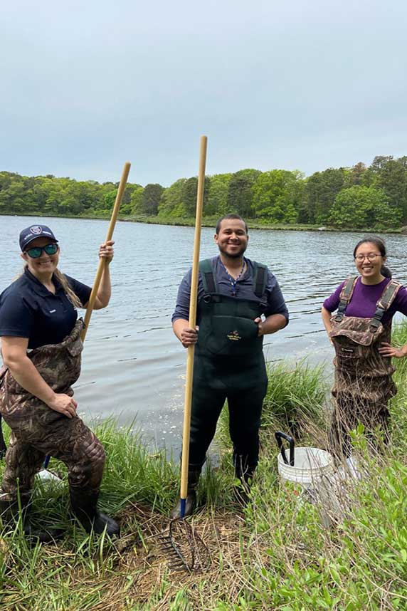 Ashley Fisher and Dale Oakley and trainee Jennifer Sun collect field samples in Mashpee, Massachusetts