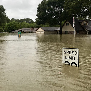 houses on flood street with sign in the foreground