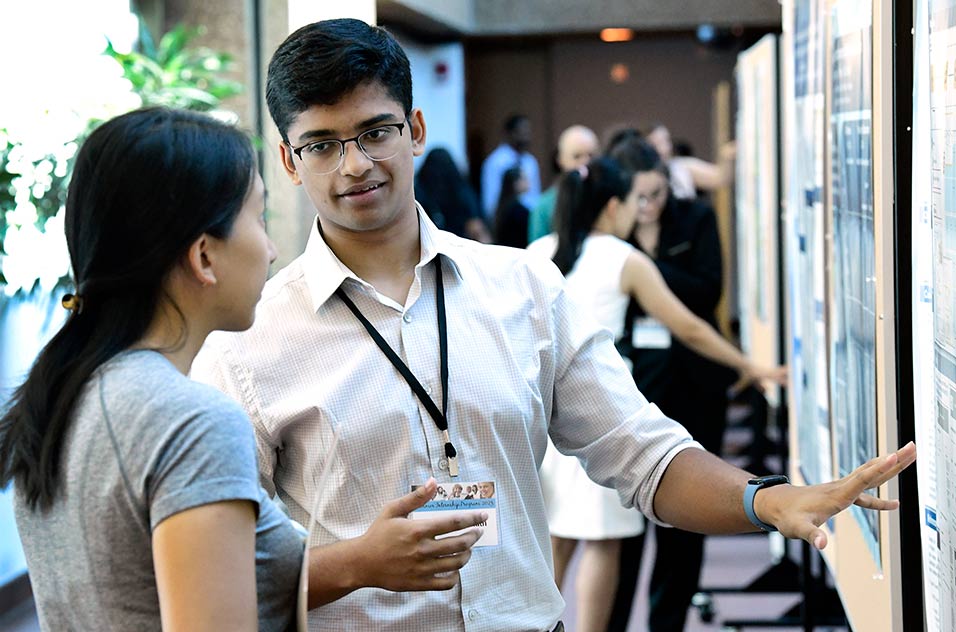 Dhruv Ranganath  explains his research during the Summer Internship Program research poster showcase held July 27 at NIEHS. 