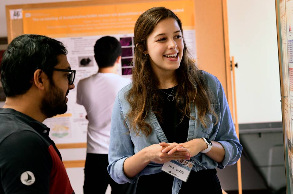 Elise Van Zele describes her poster to judge Dhakaram Pangeni Sharma, Ph.D., a visiting fellow in the Genome Stability Structural Biology Group.