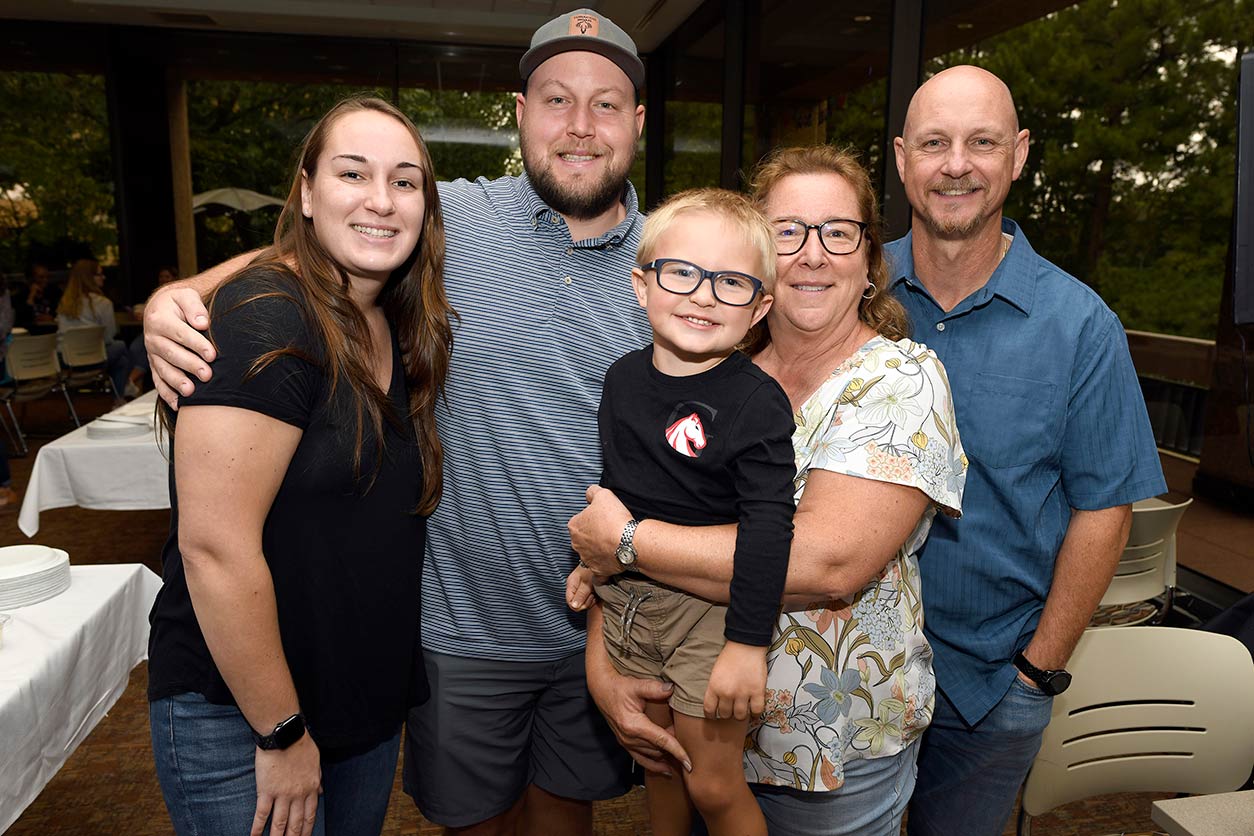 Family members, from left to right, two of her children, Emily and Eric, grandson Jack, Fenton, and husband Steve, recently joined Fenton to celebrate her contributions to NIEHS