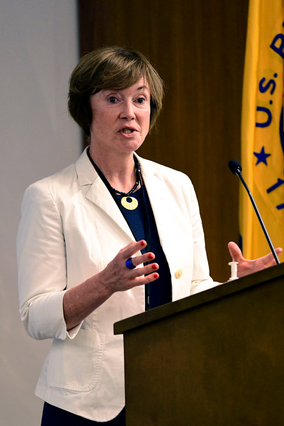 Anne Gourmelon stands at a podium