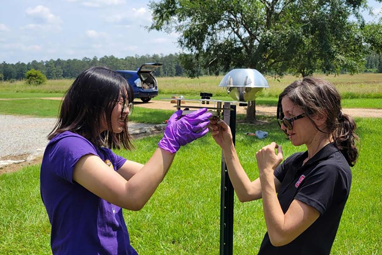 Jennifer Richmond-Bryant, Ph.D., right, and Chuqi Guo, Ph.D., left, set up measurement devices in Colfax