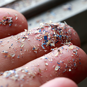 Fingers with microplastics on them