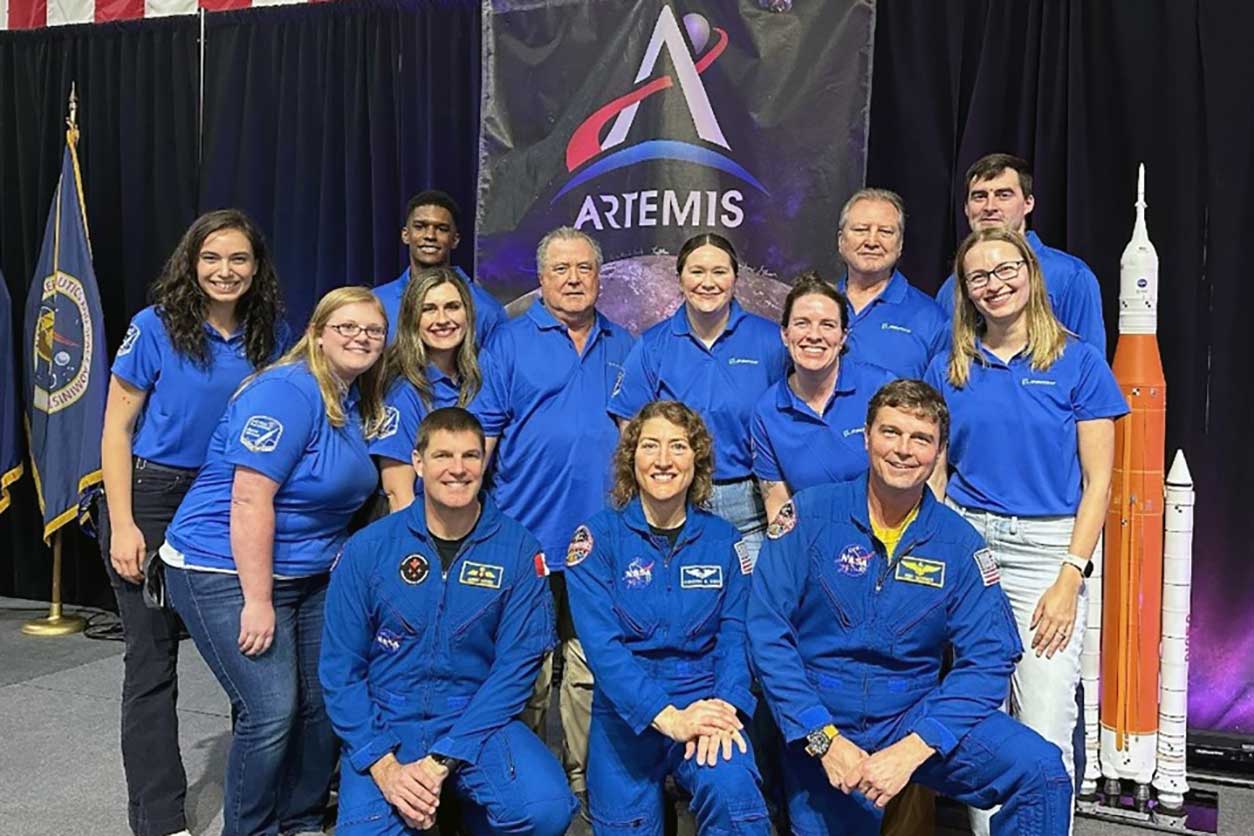 Molly Frazar Lahey, Ph.D., second row, second from right, posing with her team at Boeing and three of the astronauts selected for the Artemis II mission