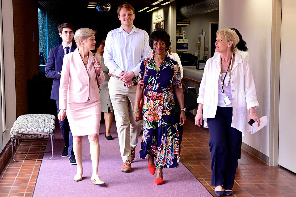 OCPL Director Christine Flowers, right, leads Valerie Foushee, center, and Deborah Ross, left, on a campus tour with stops at the NIEHS Clinical Research Unit, Fluorescence Microscopy and Imaging Center, and CryoEM core facility. (Image courtesy of Steve McCaw / NIEHS)