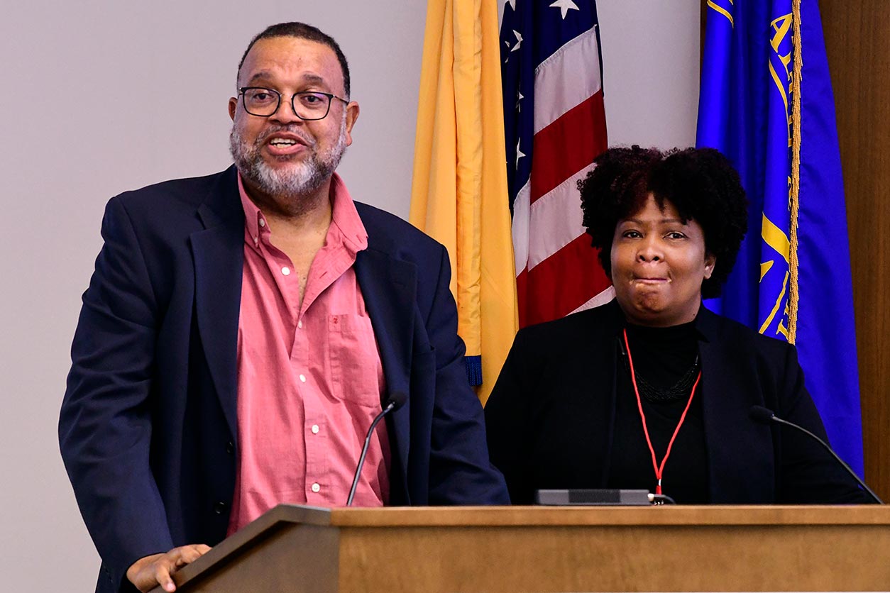 Trevor Archer, Ph.D. and Melissa Davis, Ph.D. standing behind a podium.