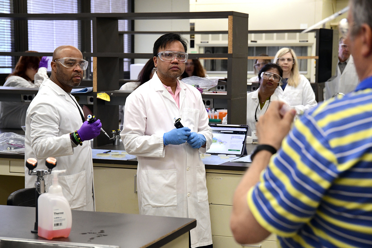 People in lab being taught proper pipetting