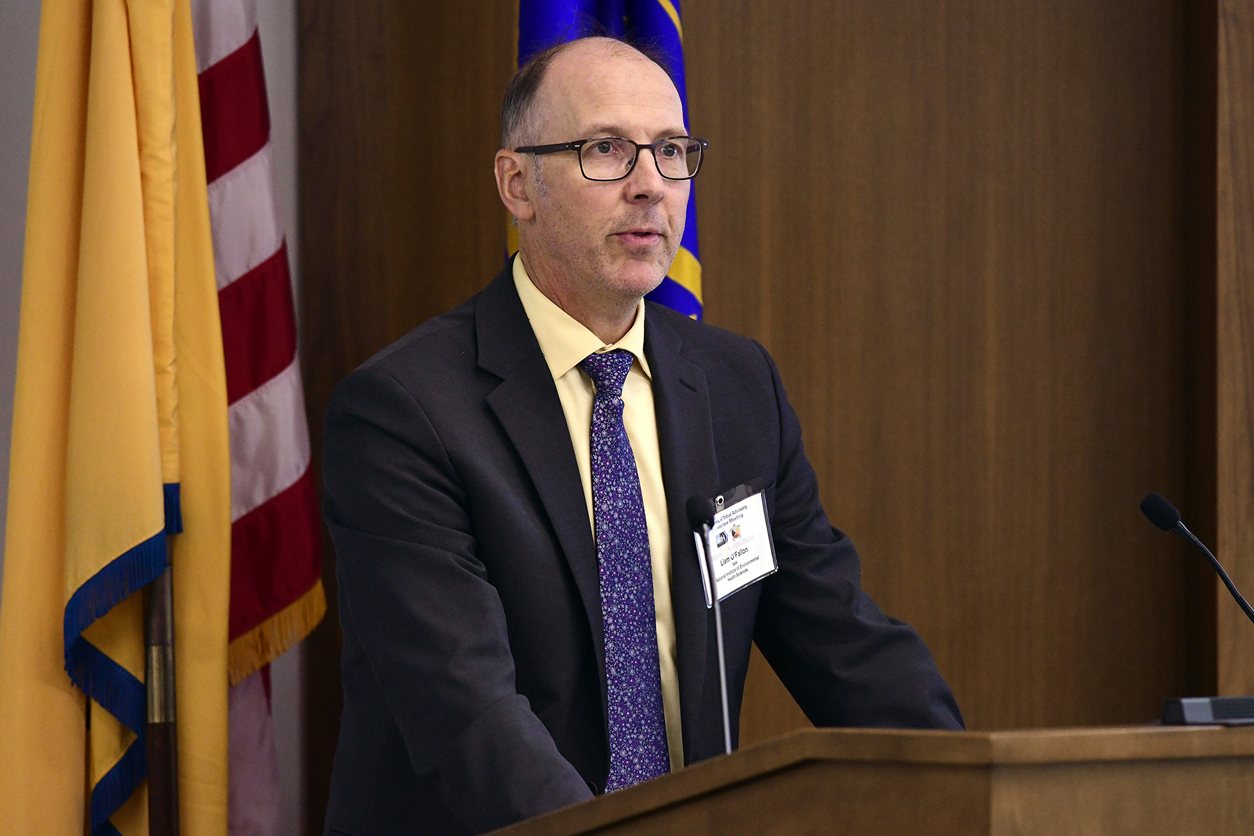 Liam O'Fallon, Ph.D. speaking at podium