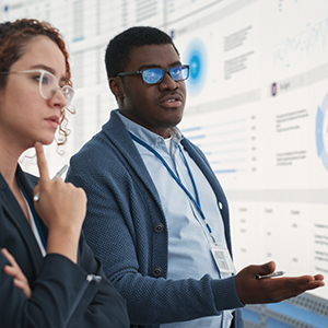 Man and woman standing in front of website projected on big screen According to Joubert, heavy metals such as lead, cadmium and arsenic are known risk factors for plaque buildup in arteries and other health problems. (Photo courtesy of Adobestock.)