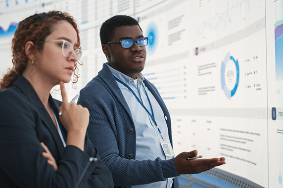 Man and woman standing in front of website projected on big screen According to Joubert, heavy metals such as lead, cadmium and arsenic are known risk factors for plaque buildup in arteries and other health problems. (Photo courtesy of Adobestock.)