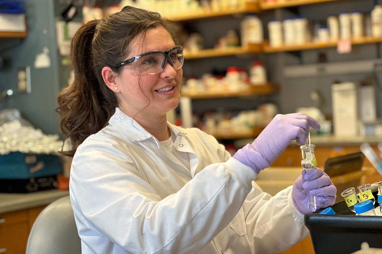 Amanda Armijo, D.V.M., Ph.D., wears safety glasses in the lab