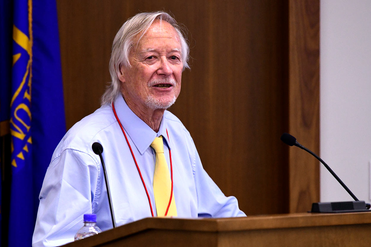 by Jack Griffith, Ph.D., of the University of North Carolina at Chapel Hill School of Medicine, stands behind a podium and microphones