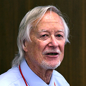 Jack Griffith, Ph.D., of the University of North Carolina at Chapel Hill School of Medicine, stands behind a podium and microphones