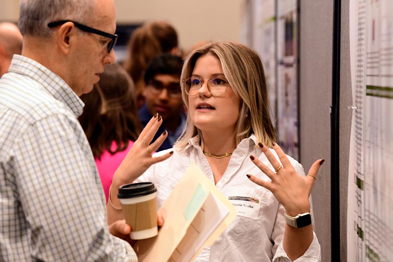 Nicole Taube, Ph.D., presenting a poster in the postdoctoral fellow category, 