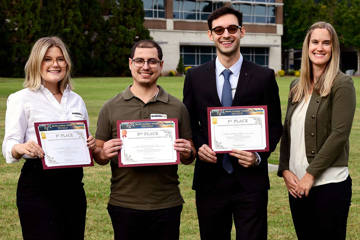 Poster award winners, left to right, Nicole Taube, Ph.D., José Teófilo Moreira Filho, Ph.D., and Ricardo Scheufen Tieghi with Kelly Shipkowski, Ph.D.