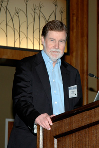 Wilson stands at a podium as he gives his award lecture
