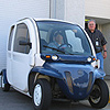 Facility Operations Branch employee Dennis Will, seated in car, and Electrical Technician Jim McDonough make daily use of the NIEHS electric car