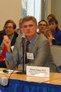 Casey speaking at a table