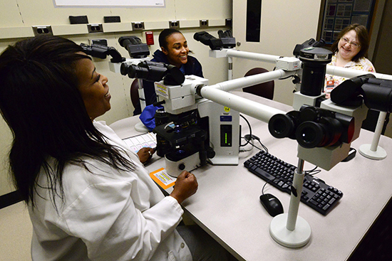 Clayton, Pettiford, and Conklin at a multiple viewer microscope
